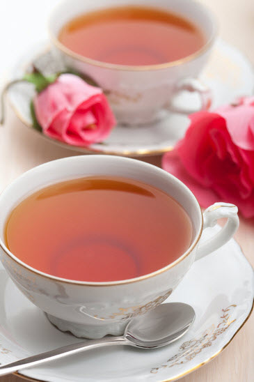 Two fancy cups of tea, with roses